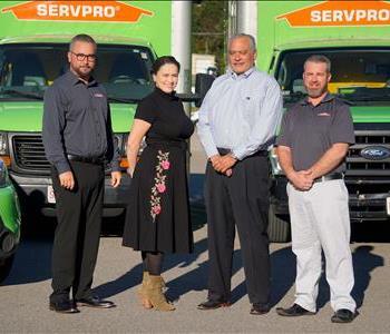 SERVPRO of Shrewsbury Business Development Team, one woman and three men standing in front of SERVPRO truck smiling